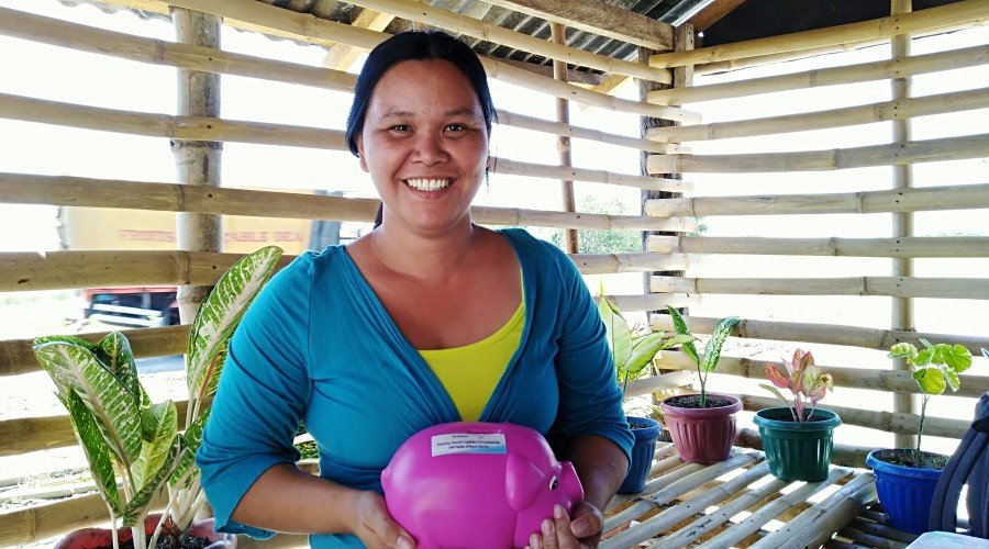 Irene Valdez con su hucha en la que puso ahorros de su pequeña tienda minorista para su proyecto de crianza de cerdos planeado Irene Valdez con su hucha en la que puso ahorros de su pequeña tienda minorista para su proyecto de crianza de cerdos planeado